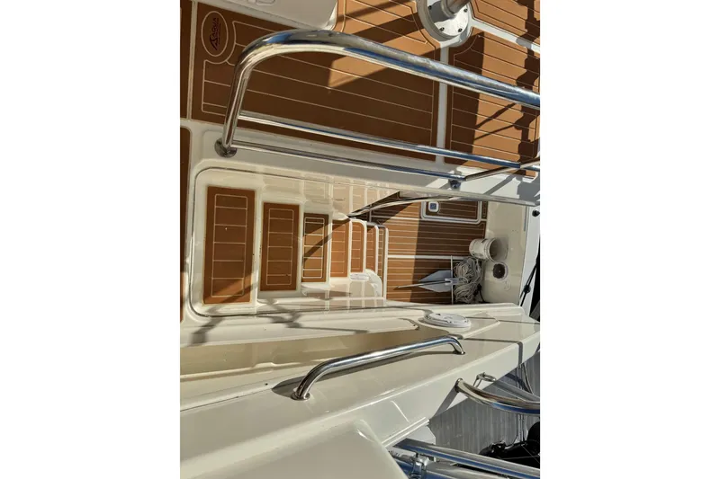 Slide: The Image of 2008 Silverton 42 Convertible yacht deck with stainless steel railings and teak flooring. - 17
