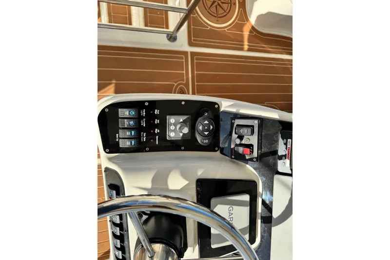 Slide: The Image of Control panel of a 2008 Silverton 42 Convertible yacht with wooden deck background. - 19