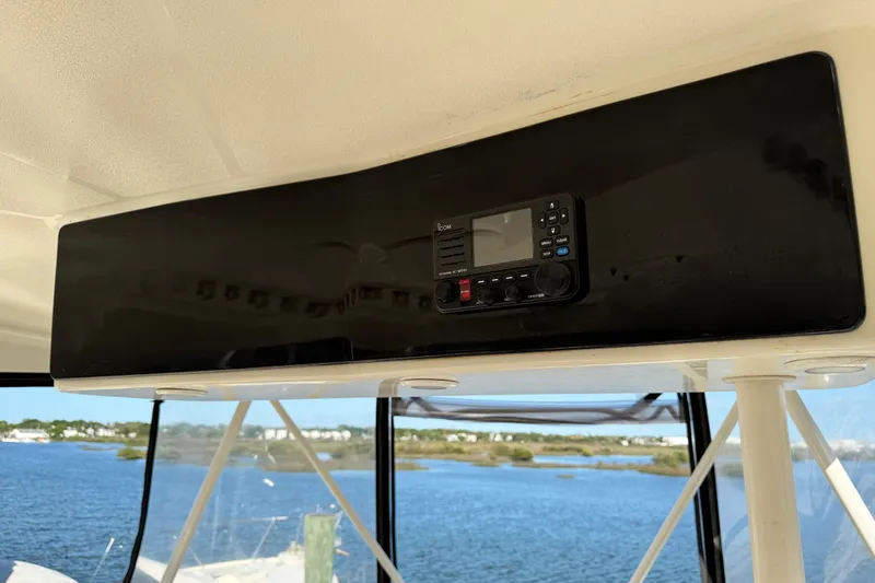 Slide: The Image of 2008 Silverton 42 Convertible boat interior with marine radio, overlooking serene water view. - 20
