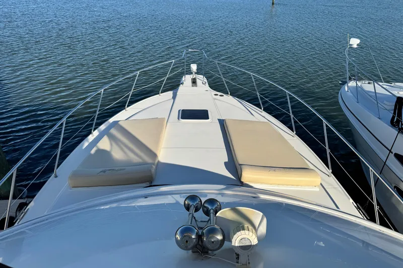 Slide: The Image of 2008 Silverton 42 Convertible yacht bow with sun pads on calm water. - 22