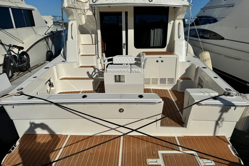 Slide: The Image of 2008 Silverton 42 Convertible yacht with spacious deck and seating area at marina. - 4
