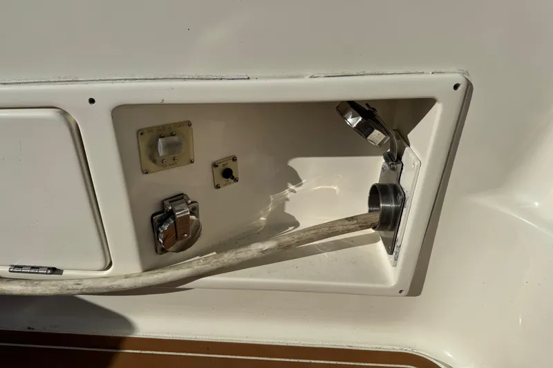 Slide: The Image of 2008 Silverton 42 Convertible yacht utility panel with hose and electrical connections. - 6