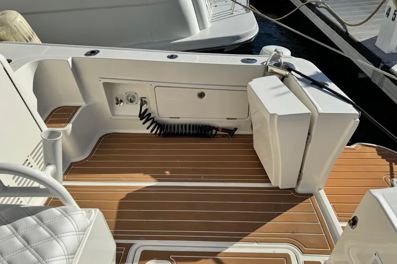 Slide: The Image of 2008 Silverton 42 Convertible boat deck with teak flooring and storage compartments. - 7