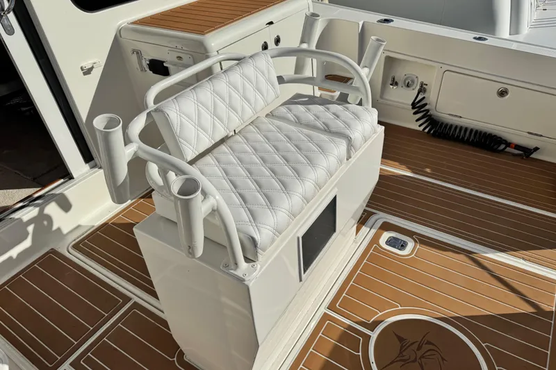 Slide: The Image of 2008 Silverton 42 Convertible boat with cushioned seating and rod holders on deck. - 8