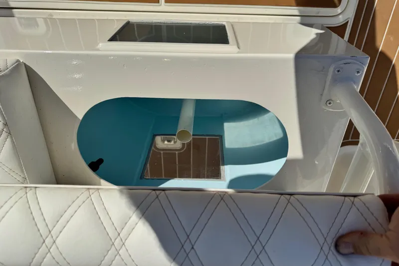 Slide: The Image of Livewell compartment on a 2008 Silverton 42 Convertible boat, featuring white and blue interior. - 9