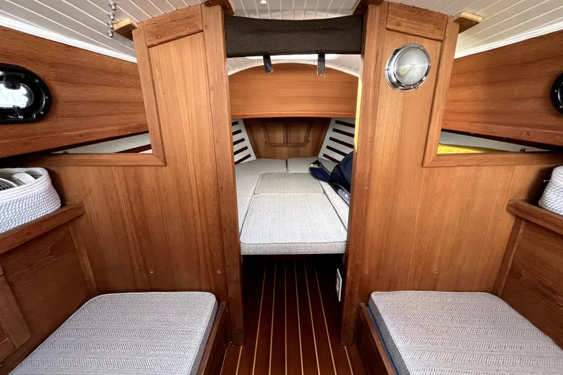 Slide: The Image of 2017 Com-Pac 23/IV sailboat interior with wooden finish and cozy seating. - 2