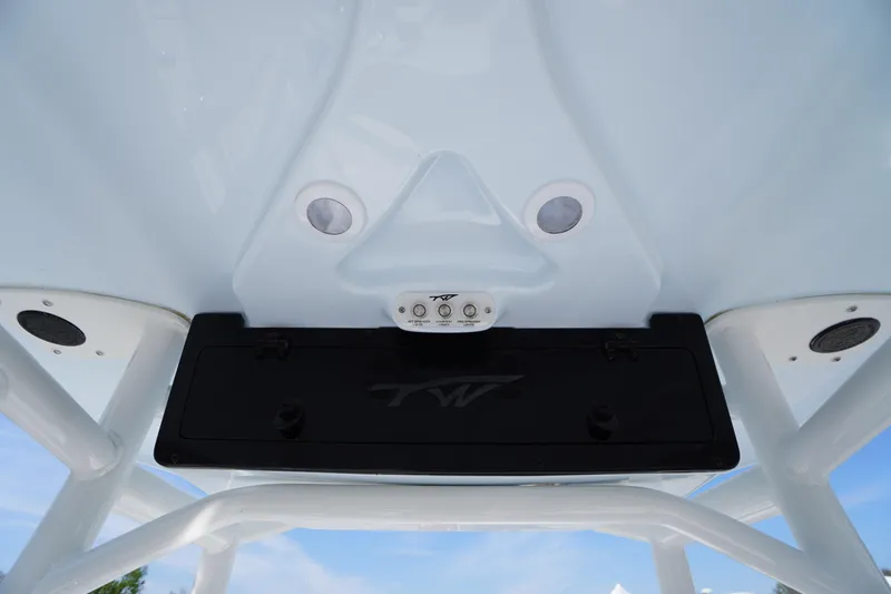 Slide: The Image of 2025 Tidewater 210 CC Adventure boat console with speakers and storage compartment. - 17