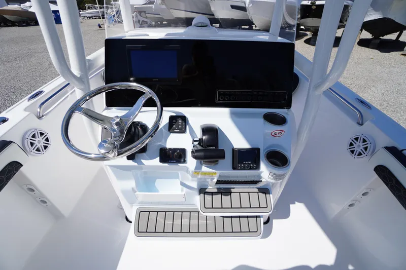 Slide: The Image of 2025 Tidewater 210 CC Adventure boat console with steering wheel and controls. - 18