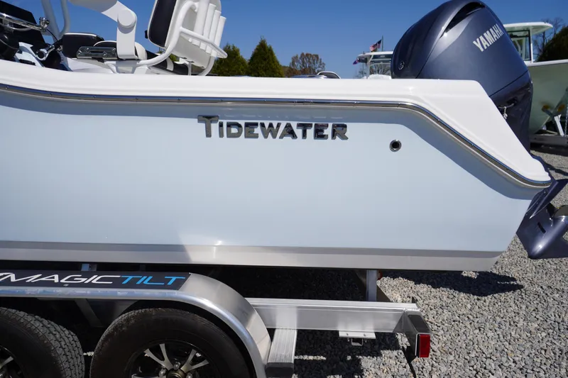 Slide: The Image of 2025 Tidewater 210 CC Adventure boat on Magic Tilt trailer, featuring Yamaha engine. - 2