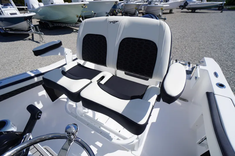 Slide: The Image of 2025 Tidewater 210 CC Adventure boat seating with black and white upholstery. - 20