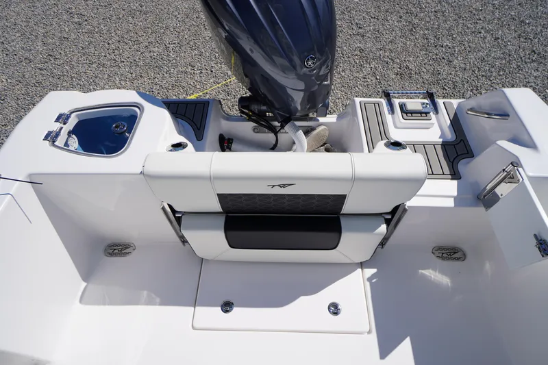 Slide: The Image of 2025 Tidewater 210 CC Adventure boat interior with seating and motor detail. - 25