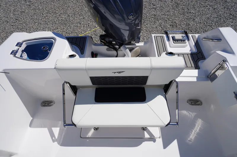 Slide: The Image of 2025 Tidewater 210 CC Adventure boat interior with seating and motor detail. - 26