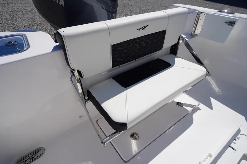 Slide: The Image of 2025 Tidewater 210 CC Adventure boat seat with sleek white and black design. - 27