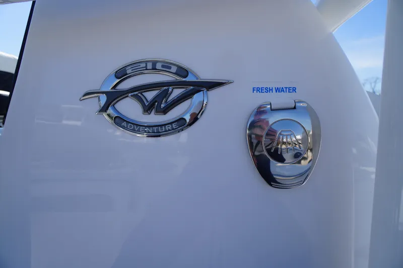 Slide: The Image of 2025 Tidewater 210 CC Adventure boat emblem and fresh water access. - 33