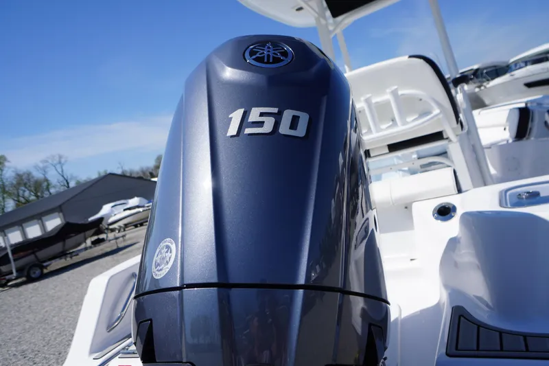 Slide: The Image of 2025 Tidewater 210 CC Adventure boat with a 150 horsepower engine, docked outdoors. - 36