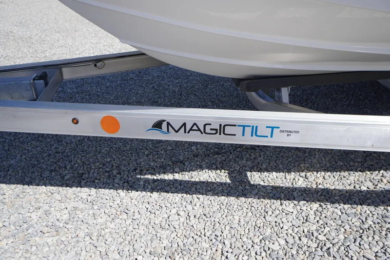 Slide: The Image of Trailer for 2025 Tidewater 210 CC Adventure boat by Magic Tilt on gravel surface. - 38