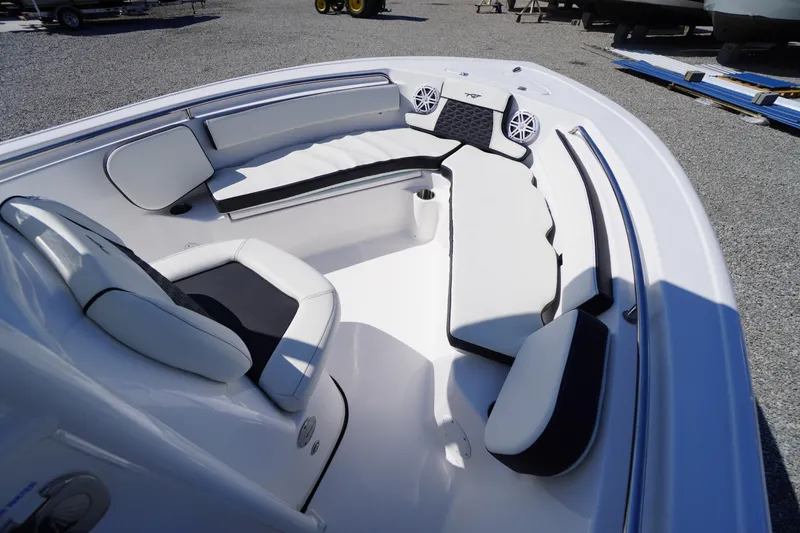 Slide: The Image of 2025 Tidewater 210 CC Adventure boat interior with white seating and speakers. - 4