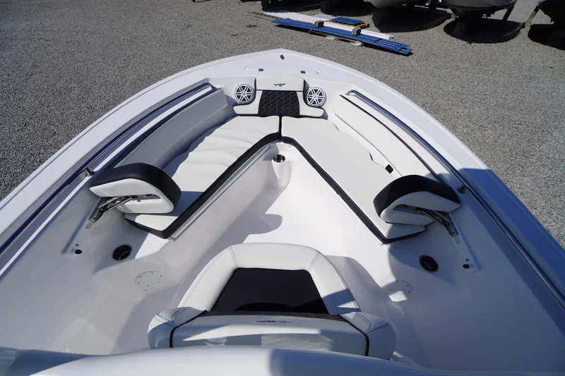 Slide: The Image of 2025 Tidewater 210 CC Adventure boat interior with white seating and speakers. - 5