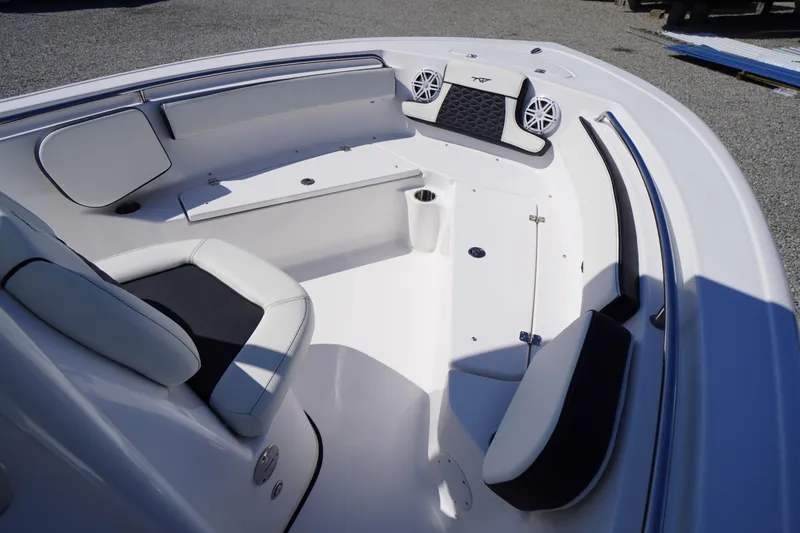 Slide: The Image of 2025 Tidewater 210 CC Adventure boat interior with cushioned seating and speakers. - 8