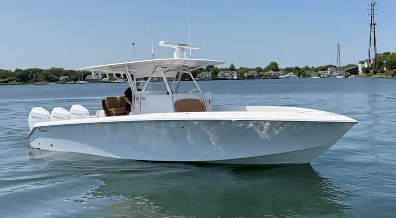 The Image of 2025 Bahama 35 Super Center Console boat on calm water, clear sky background. - 0