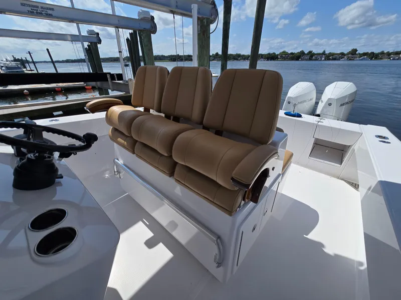 Slide: The Image of 2025 Bahama 35 Super Center Console boat with tan seating and dual Mercury engines. - 10