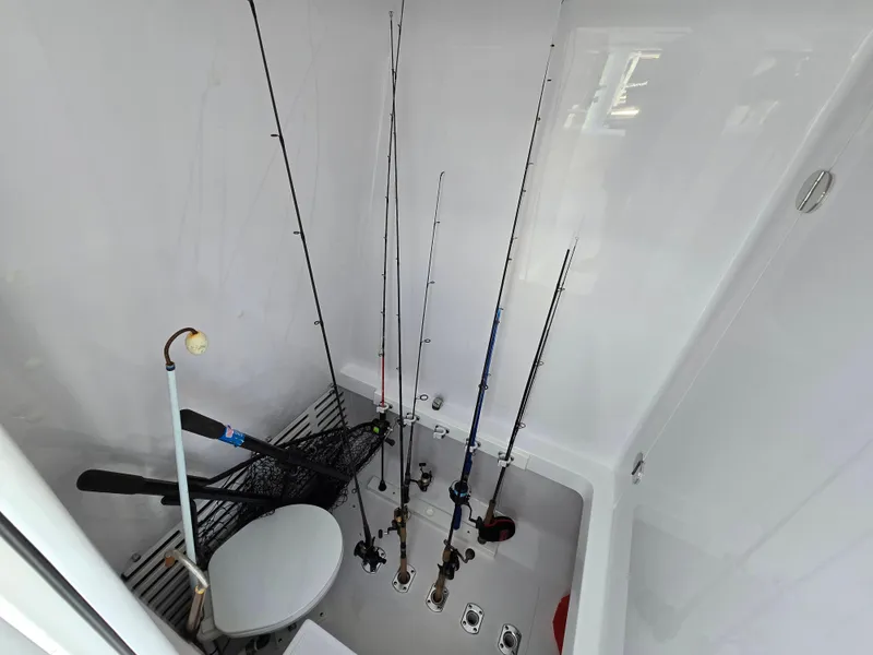 Slide: The Image of Fishing rods and gear stored in 2025 Bahama 35 Super Center Console boat compartment. - 23