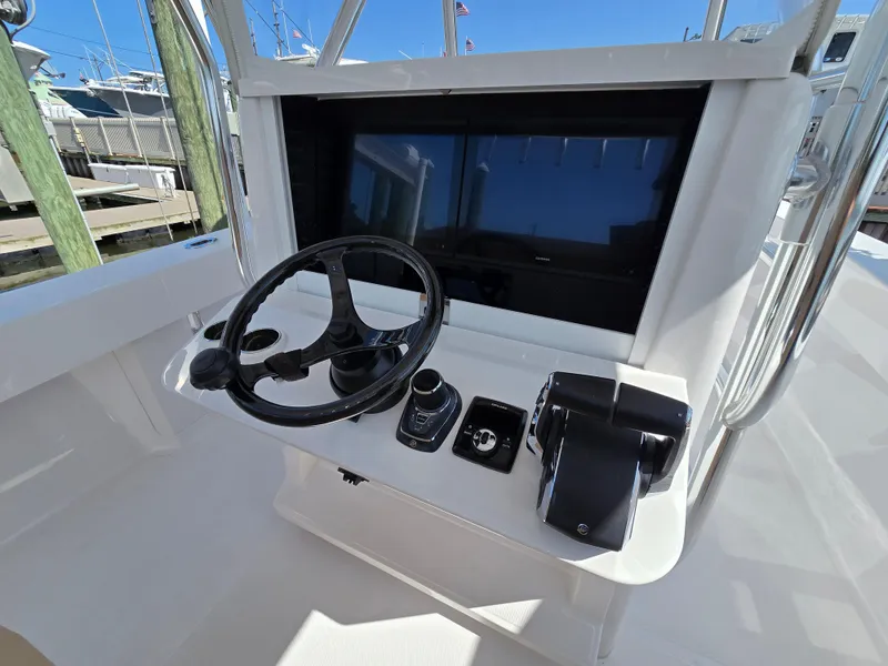 Slide: The Image of Center console of 2025 Bahama 35 Super, featuring steering wheel and controls. - 4