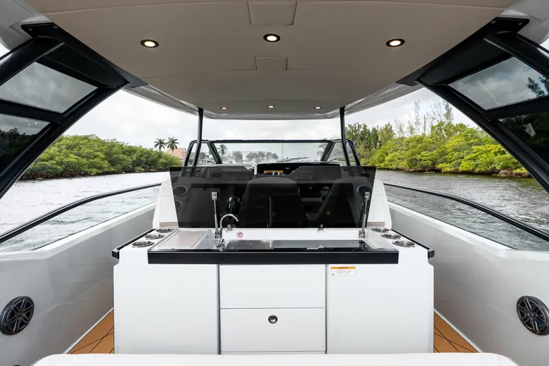 Slide: The Image of 2024 Saxdor 320 GTO boat interior with sleek design and modern amenities on a scenic waterway. - 17