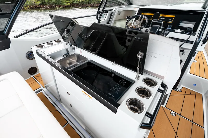 Slide: The Image of 2024 Saxdor 320 GTO boat interior with modern kitchen and steering console. - 19
