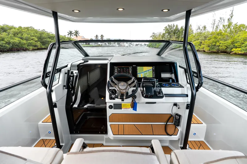 Slide: The Image of 2024 Saxdor 320 GTO cockpit with modern navigation system and sleek design on open water. - 20