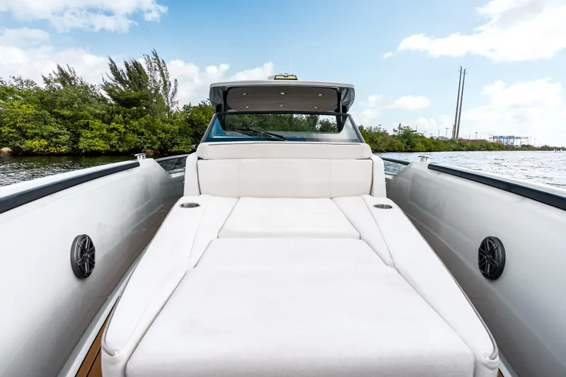 Slide: The Image of 2024 Saxdor 320 GTO boat interior with luxurious seating, surrounded by scenic waterway. - 24