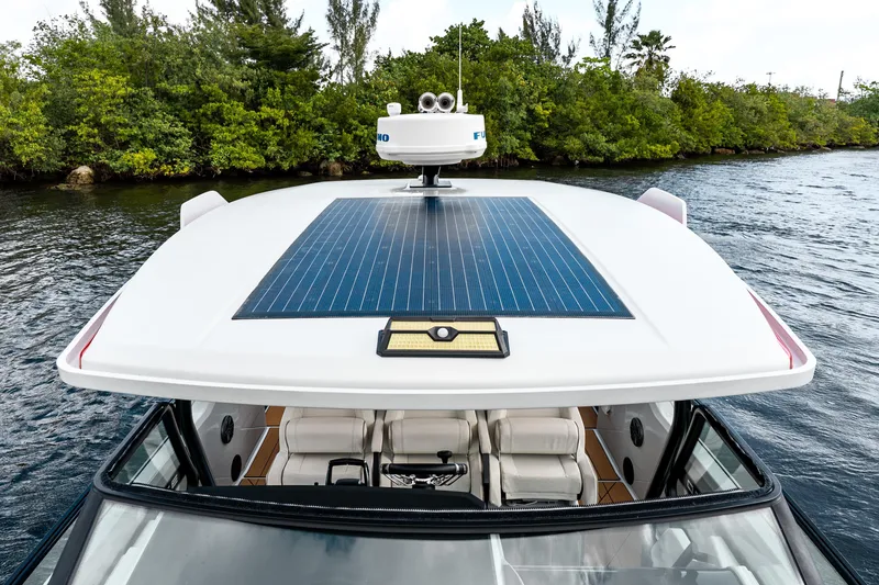 Slide: The Image of 2024 Saxdor 320 GTO boat with solar panel, cruising on a scenic waterway. - 26