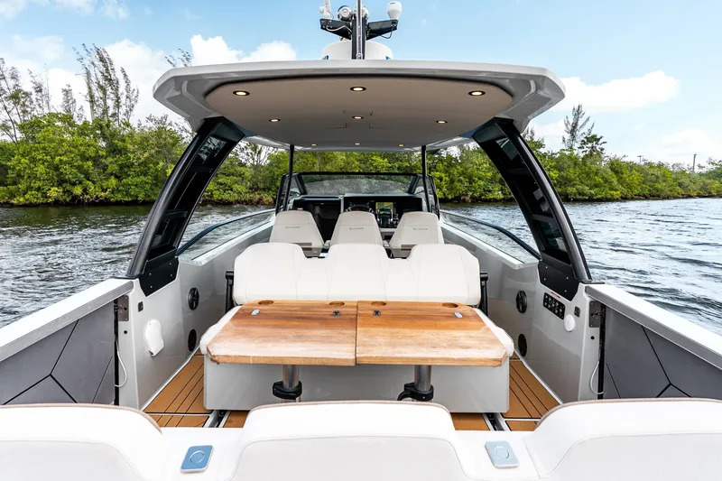 Slide: The Image of 2024 Saxdor 320 GTO luxury boat interior with seating and wooden table on water. - 34