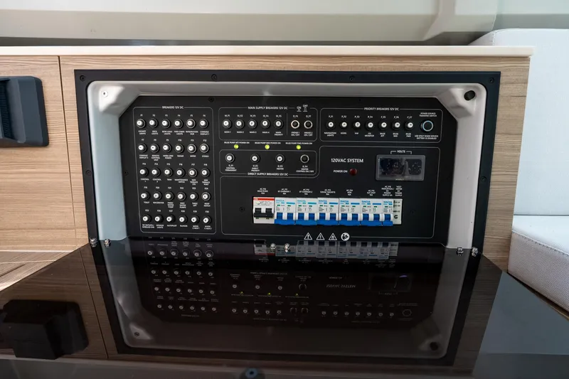 Slide: The Image of Electrical control panel on 2024 Saxdor 320 GTO boat, featuring various switches and breakers. - 42