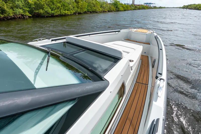 Slide: The Image of 2024 Saxdor 320 GTO cruising on a scenic river with lush greenery. - 9