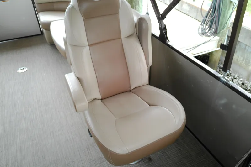 Slide: The Image of Captain's chair on 2016 Veranda Relax V2275RC pontoon boat, featuring beige upholstery. - 12