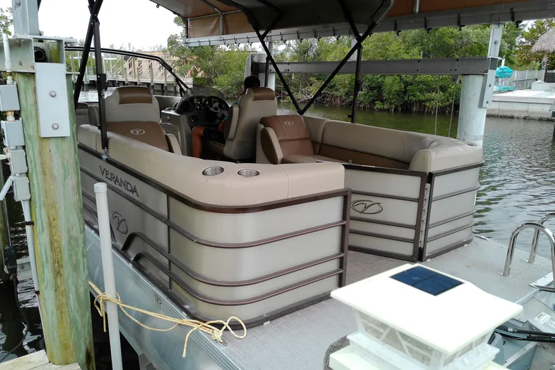 Slide: The Image of 2016 Veranda Relax V2275RC pontoon boat docked by the water. - 14