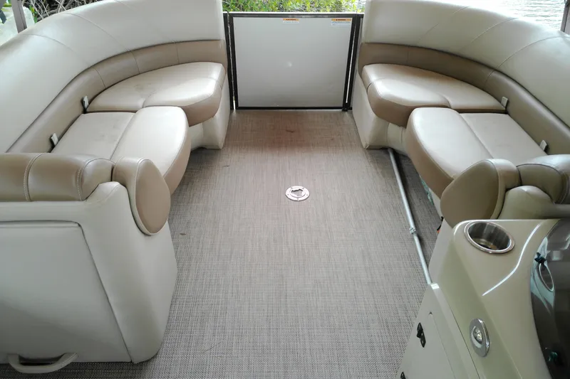 Slide: The Image of 2016 Veranda Relax V2275RC pontoon boat interior with beige seating and carpeted floor. - 4