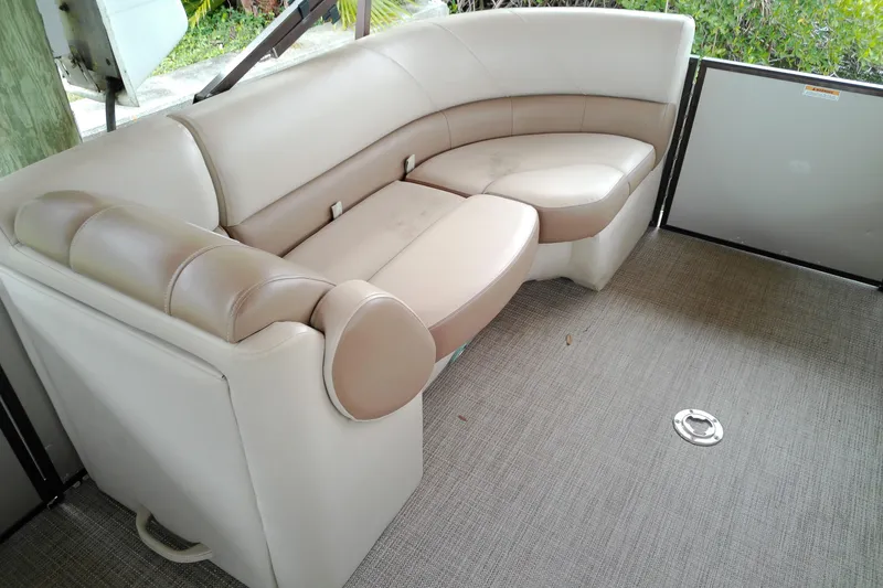Slide: The Image of 2016 Veranda Relax V2275RC boat interior with beige seating and carpeted floor. - 7