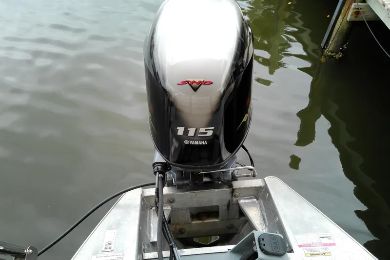 Slide: The Image of Outboard motor on 2016 Veranda Relax V2275RC boat, docked on calm water. - 9
