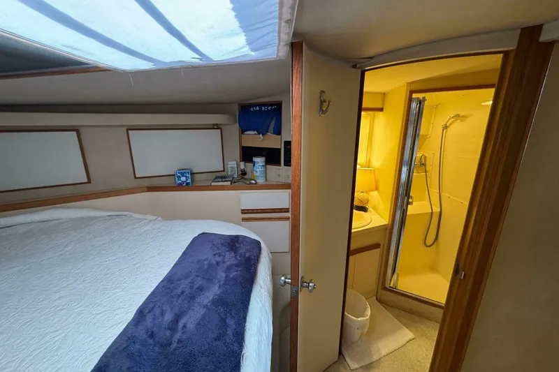 Slide: The Image of Interior of 1989 Bertram 50 Convertible yacht with cozy bedroom and ensuite bathroom. - 12