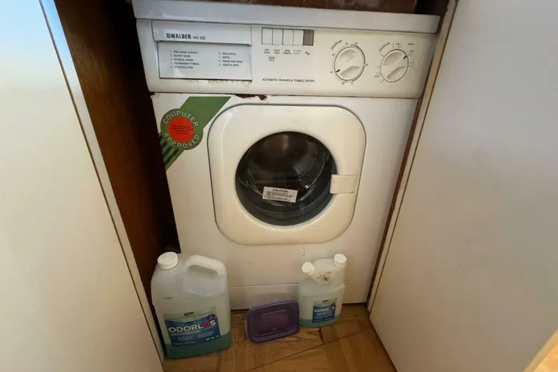 Slide: The Image of Compact washing machine in a Bertram 50 Convertible yacht, 1989 model, with cleaning supplies. - 13