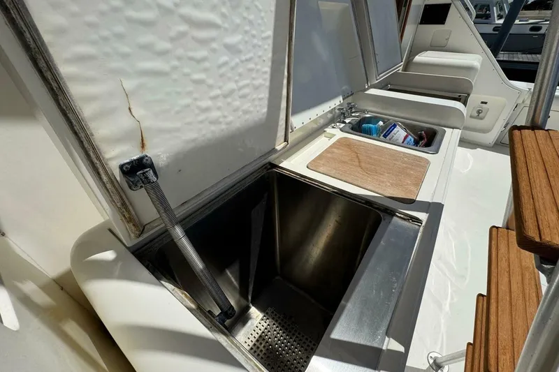 Slide: The Image of Outdoor sink and storage area on a 1989 Bertram 50 Convertible yacht. - 15
