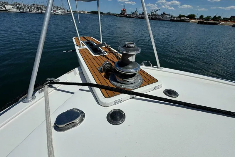Slide: The Image of Bow of 1989 Bertram 50 Convertible yacht with winch, docked in marina. - 17