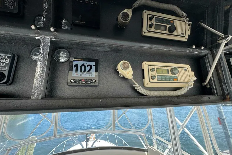 Slide: The Image of Control panel of a 1989 Bertram 50 Convertible boat with navigation instruments. - 18