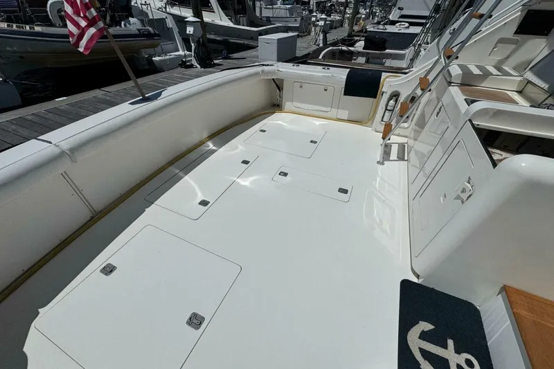 Slide: The Image of 1989 Bertram 50 Convertible yacht deck with storage hatches and American flag. - 22