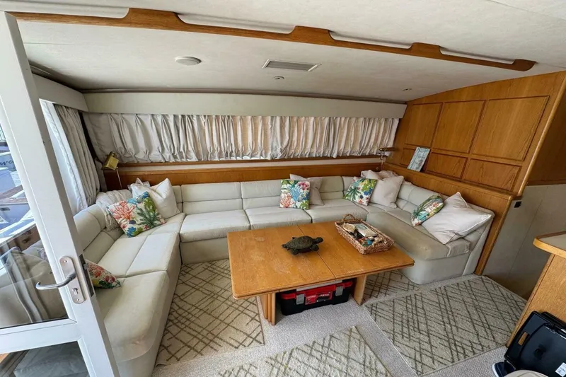 Slide: The Image of Luxurious interior of a 1989 Bertram 50 Convertible yacht with plush seating and wooden accents. - 5