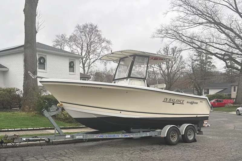 The Image of 2005 Sailfish 236 CC boat on trailer in suburban neighborhood. - 0