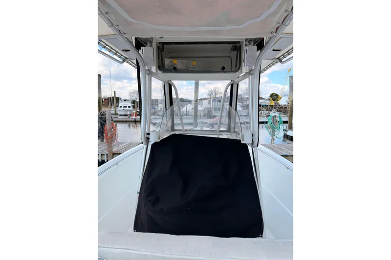 Slide: The Image of 2005 Sailfish 236 CC boat interior with covered console at marina. - 14
