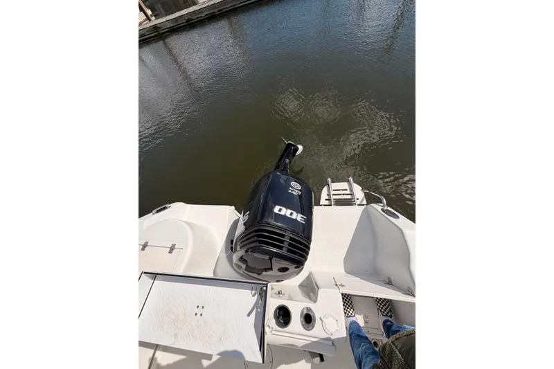 Slide: The Image of 2005 Sailfish 236 CC boat with 300 HP engine on calm water. - 16